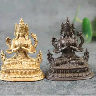 2 statues de Shiva (doré et marron) assis sur un socle
