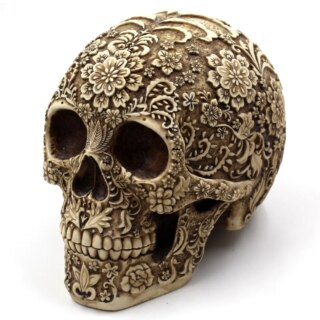 Statue de tête de mort sculptée avec des fleurs