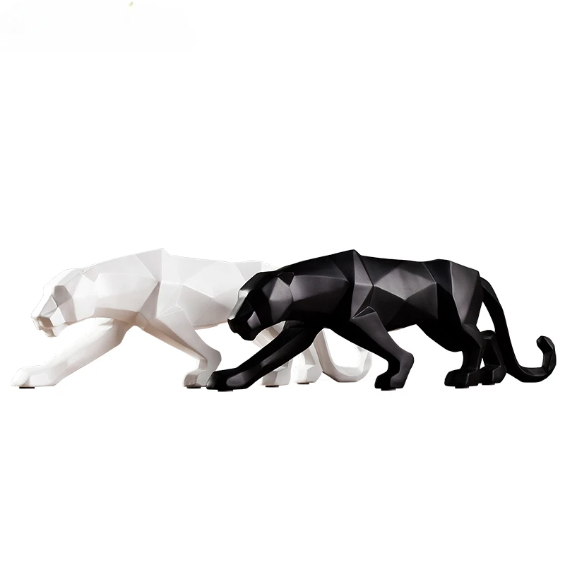 Statues de panthères noire et blanche sur fond blanc.