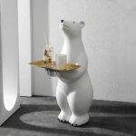 On voit une statue d'ours polaire qui porte un plateau doré qui sert d'étagère.