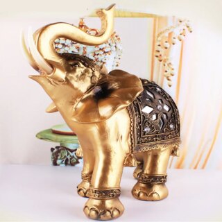 Statue d'éléphant doré la tête et la trompe levés