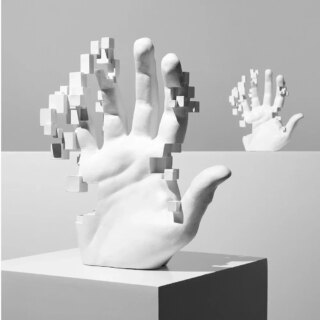 Statue main artistique abstraite qui se décompose en pixel
