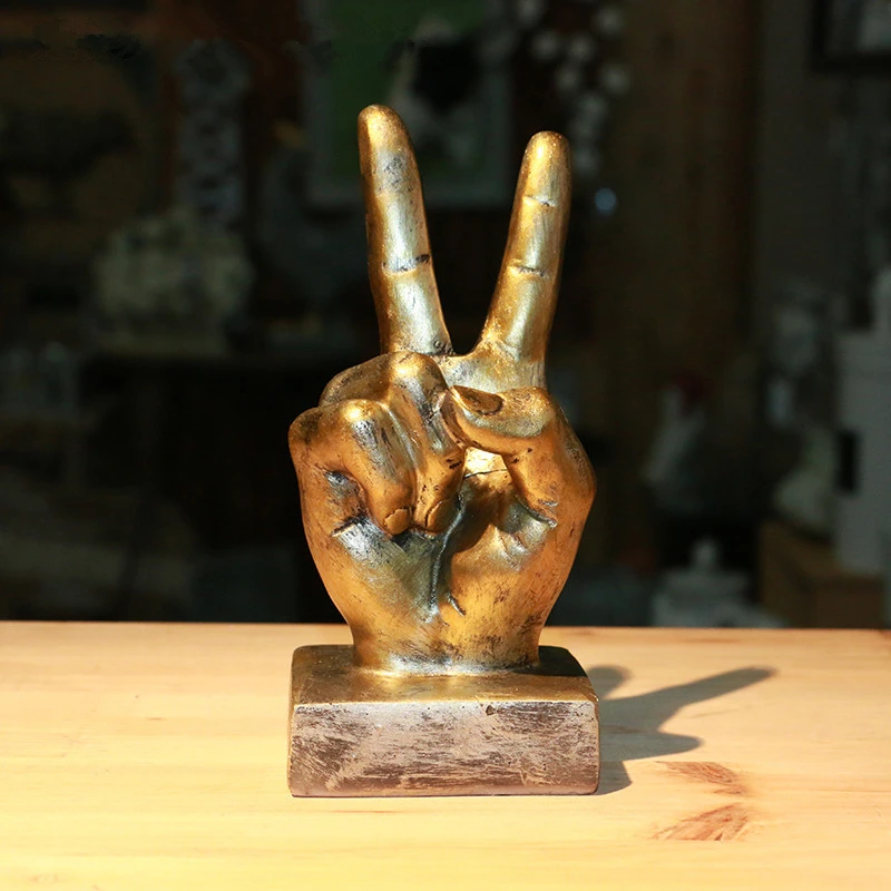 2062-pscrhl.jpg Statue main signe peace couleur bronze avec socle posée sur une table