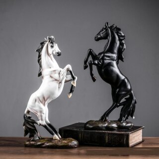 Deux statues de chevaux se cabrant sur un fond gris.